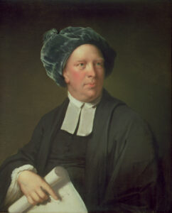 Portrait of a man dressed as clergy, holding a scroll of paper, wearing a floppy blue hat.