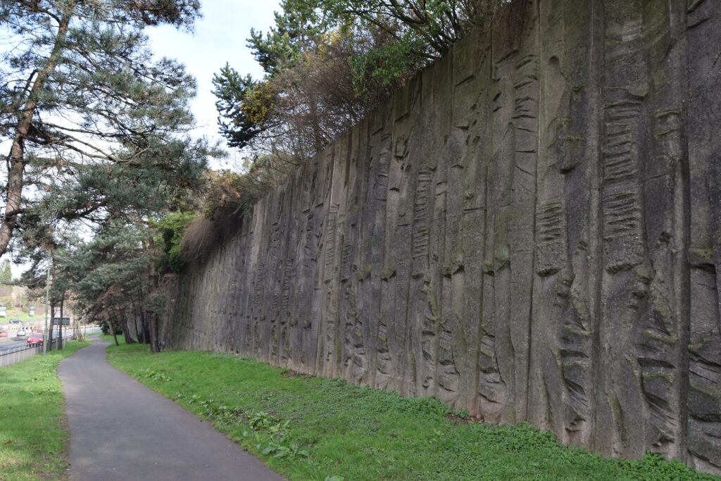 This retaining wall with decorative sculptural relief by William Mitchell, in Kidderminster, was listed in 2020 for its architectural and historic interest.